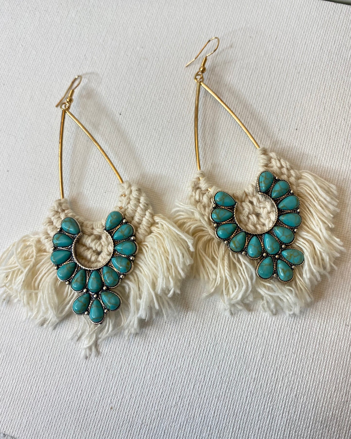 White crochet earrings with turquoise squash blossom