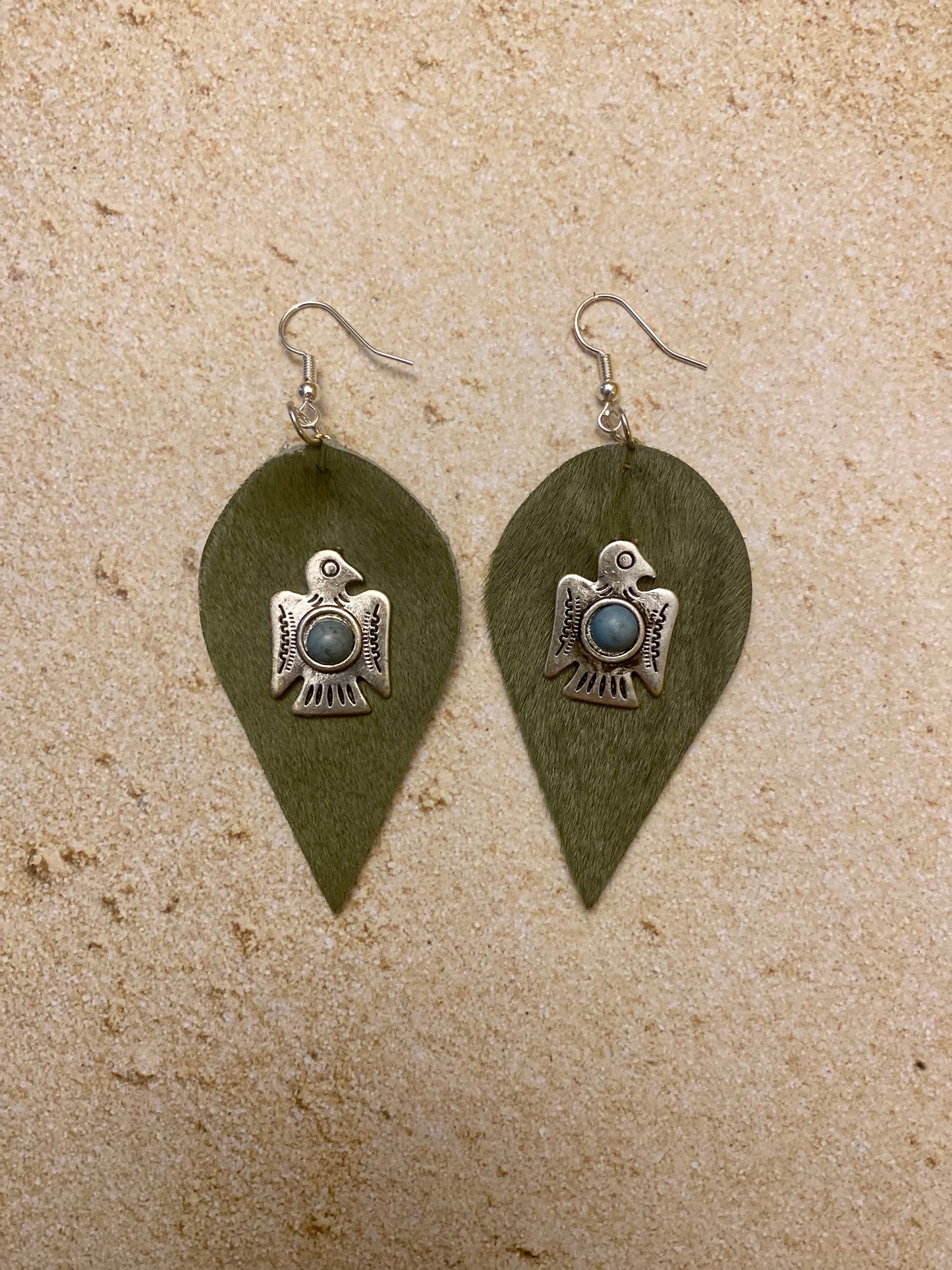 Green cowhide thunderbird with turquoise earrings